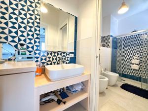 a bathroom with a sink and a toilet at La Campanella - De Vivo Realty in Termini +14 photos