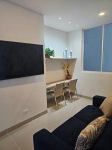 a living room with a couch and a tv on a wall at Luxury Aparment in Reserva del Mar in Gaira