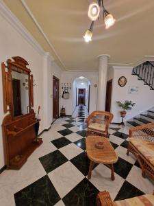 a living room with a black and white checkered floor at Villa los Dulces-Piscina Privada in Letur