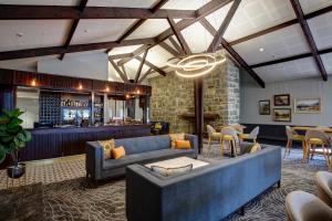 a lobby with a blue couch and a bar at The Hermitage Hotel Mt Cook in Mount Cook Village