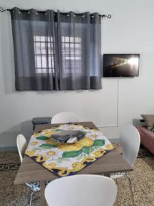a dining room table with a table cloth on it at CASA Zia Sarina in Noto