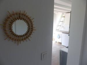 a mirror hanging on a wall in a room at Logement idéal au centre-ville in Cavalaire-sur-Mer