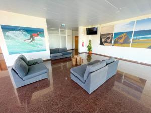 a living room with two couches and a tv at HI Santa Cruz - Pousada de Juventude in Santa Cruz
