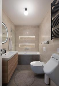 a bathroom with a sink and a toilet and a tub at Villa Voyage in Zadar