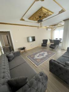 sala de estar con sofá, sillas y TV en Yılmaz Bey Konağı, en Termal