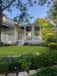 a white house with a gazebo at Williston Village Inn in Burlington