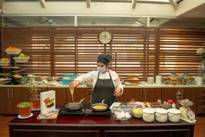 a person in a kitchen preparing food in a kitchen at Four Points by Sheraton Santiago in Santiago
