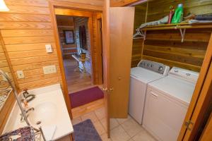 a bathroom with a washer and dryer in a cabin at Sweet Retreat in Boone +15 photos