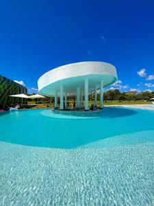 a building with a pool of water in front of it at Xeliter Cana Rock Punta Cana in Punta Cana