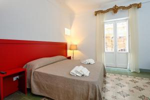 a bedroom with a bed with two towels on it at Principe di Bigottia in Trapani