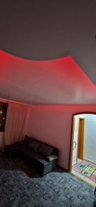 a bedroom with a red ceiling with a bed and a mirror at ANASTASIA. in Tulcea