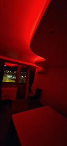 a dark room with red lights on the ceiling at ANASTASIA. in Tulcea