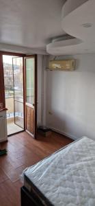 a bedroom with a bed and a door to a balcony at ANASTASIA. in Tulcea