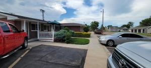 two cars parked in front of a house at Husker Inn in North Platte