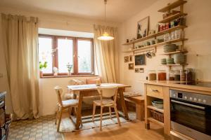a kitchen with a table and chairs and a window at WandelRaum gGmbH in Frasdorf