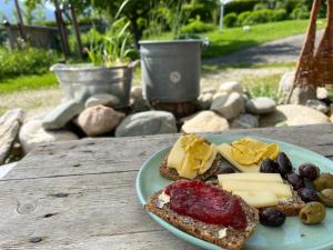 a plate of food on a table with cheese and bread at WandelRaum gGmbH in Frasdorf