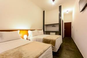 Un pat sau paturi într-o cameră la Hotel Fazenda Aguas de Lindoia