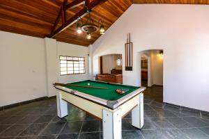 a pool table in the middle of a room at Hotel Fazenda Aguas de Lindoia in Águas de Lindóia