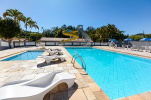 a swimming pool with a slide in a resort at Hotel Fazenda Aguas de Lindoia in Águas de Lindóia