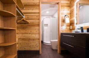 a bathroom with a toilet and wooden walls at Sunrise Valley Suite in West Kelowna +50 photos