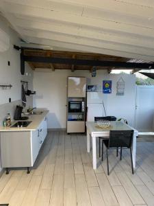 a kitchen with a table and a refrigerator at Blue dream Bungalow in Le Gosier