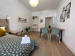 a bedroom with a bed and a table and chairs at Appartamento Millelire in Rome
