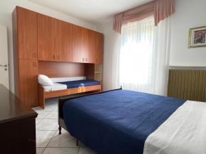 a bedroom with a blue bed and a window at Ca' del Monte in Roncofreddo