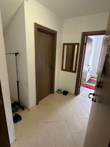 a hallway with a door and a tile floor at Penthouse Harriet Bansko in Bansko