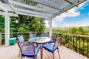 a patio with a table and chairs on a deck at Mountain Lake Retreat in Groveland
