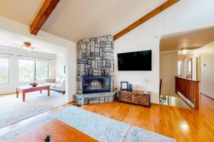 a living room with a fireplace and a tv at Mountain Lake Retreat in Groveland