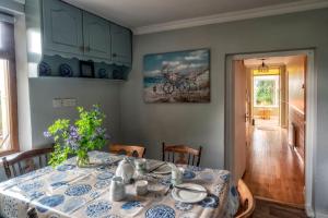 a dining room table with a blue and white table cloth at Maryfields Farmhouse in Castlemaine