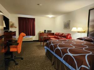 a hotel room with a bed and a desk at Super 8 by Wyndham Taber AB in Taber