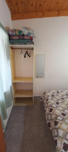 a bedroom with a bed and a wooden ceiling at Cuty Nakey in Puerto Madryn