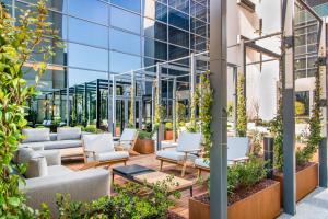 an outdoor patio with chairs and a building at Four Points by Sheraton Venice Mestre in Mestre