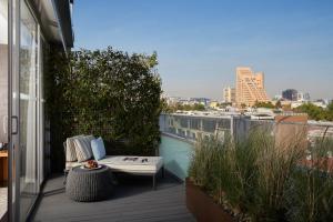 a balcony with a bench and a view of a city at Las Alcobas, a Luxury Collection Hotel, Mexico City in Mexico City