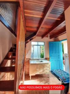 a kitchen with a sink and a staircase in a room at Chalé da Léia in Conceição da Ibitipoca