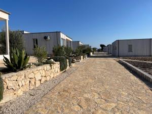 a cobblestone street in front of a row of buildings at BUQEZ ECO RESORT - Beach Villas 2 and 8 - Seaview, new wifi! in Drage