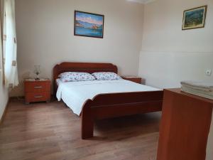 a small bedroom with a bed and a night stand at Apartment Marta in Kotor