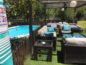 a row of beds next to a swimming pool at Karma House in Casares
