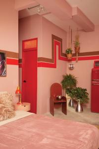 a bedroom with a bed and a red door at MOOD HAUS by DW in San Juan