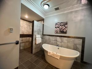 a bathroom with a large tub and a shower at Wells Gray Inn in Clearwater