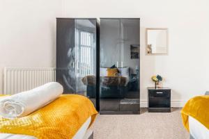 a bedroom with a bed and a glass wall at Home Near Anfield and Everton FC with FREE Parking in Liverpool