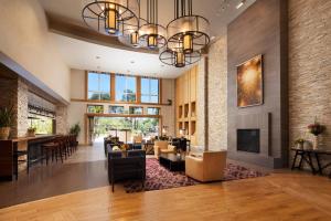 a living room with a fireplace and a dining room at The Westin Verasa Napa in Napa