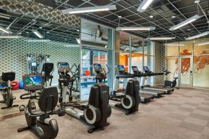 a gym with treadmills and elliptical machines at Aloft Houston by the Galleria in Houston