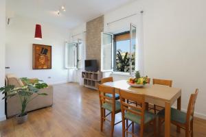 a dining room and living room with a table and chairs at Franco's house Sorrento in Sorrento