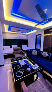 a living room with a couch and a table at HOTEL 11 SWEET ROOMS in Islamabad