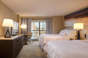 a hotel room with two beds and a balcony at The Westin Tampa Waterside in Tampa