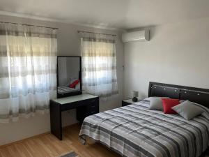 a bedroom with a bed and a desk and a mirror at Apartments by the sea Susica, Ugljan - 21389 in Ugljan