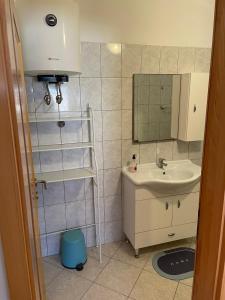 a bathroom with a sink and a mirror at Apartments by the sea Susica, Ugljan - 21389 in Ugljan