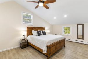 a bedroom with a bed and a ceiling fan at Fantastic retreat 5min from Village w/ media room! in Stowe